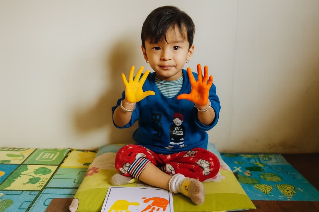 Play Group student with painted hands